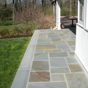 This masonry patterned bluestone patio shows the natural colors and variation of the stone.