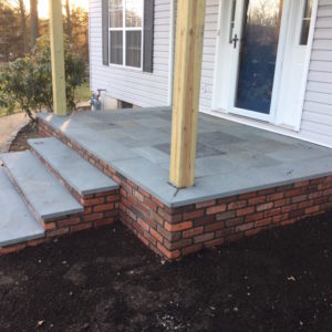 These existing steps and landing were resurfaced with a brick veneer and capped with natural bluestone.