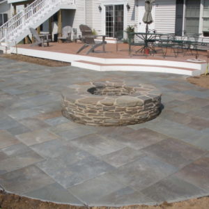 This large patterned bluestone patio provides ample space for large gatherings by the firepit.