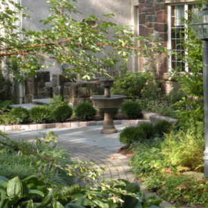 This fountain area and landscape was designed as focal point along the front walkway.