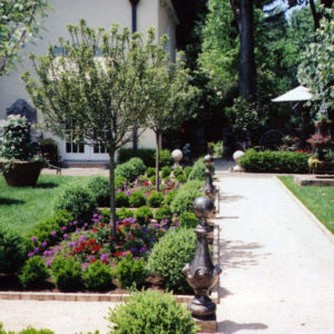 This walkway was created using compacted gravel with brick edging to give this Mediterranean garden a formal appearance.