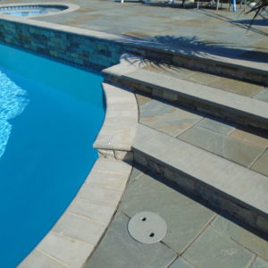 These natural stone steps capped with bluestone leads guests to the upper pool patio.