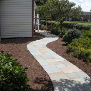 This colorful natural bluestone walkway meanders through the landscape to the front door.