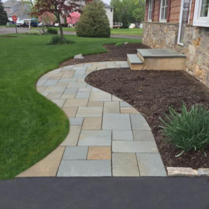 The design of this bluestone walkway blends seamlessly with the curves of the bedlines.