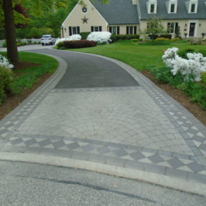 A detailed paver design makes this driveway entrance unique.