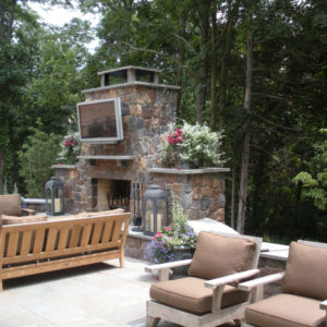 This custom built natural stone fireplace creates a great outdoor living space to relax and entertain.