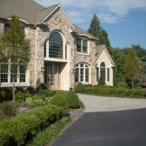 This balanced formal entrance design works in perfect harmony with the home's architecture.