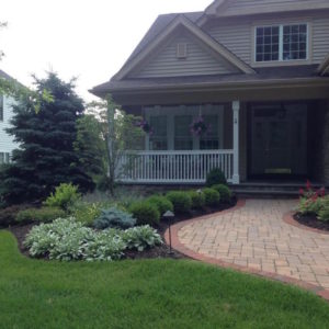 This curving paver walkway with a beautiful mix of plantings provides interesting curb appeal.