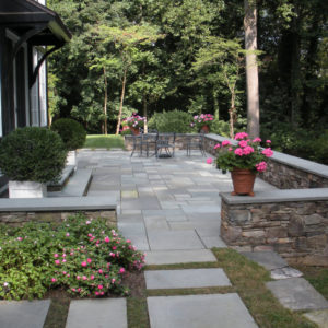 This outdoor living space was created using patterned Pennsylvania bluestone, allowing the patio to blend into its natural surroundings.