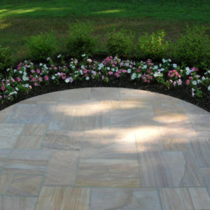 This curved, natural sandstone landing makes a dramatic entrance to the home.
