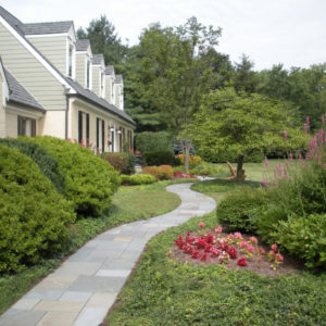 The front walkway design for this patterned bluestone walk makes for an inviting entrance to the home.