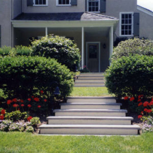 These bluestone capped masonry steps with a stucco finish are an inviting way to lead you into this terraced garden area.