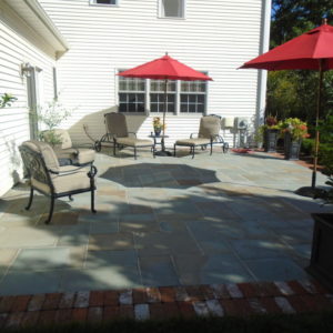 The brick edging adds an element of interest to this colorful pattern Pennsylvania bluestone patio.