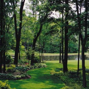 This inviting woodland path with shade plantings allows one to visit the pond.